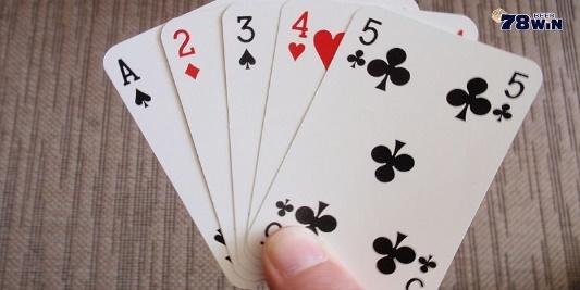 A hand holding playing cards

Description automatically generated